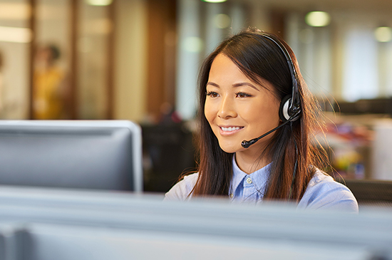 young lady smiling on a headset in call centre