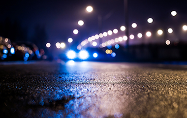 Car with headlights on at night