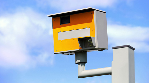 Speed camera with clear blue sky in the background