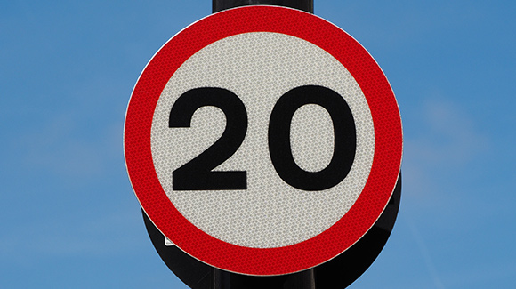 20 mile per hour repeater sign on lamp post