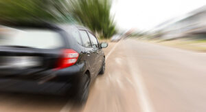 Black car speeding on UK road