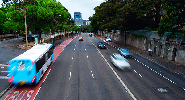 traffic travelling along a busy road with bus lane